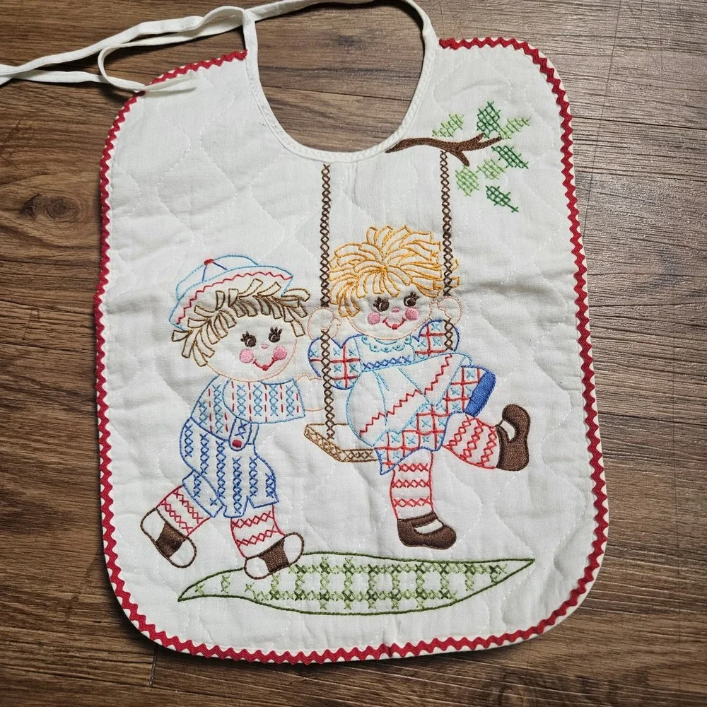 Lot of 2 Vintage Quilted Baby Bibs Embroidered Raggedy Ann Kite Swing Ric Rac